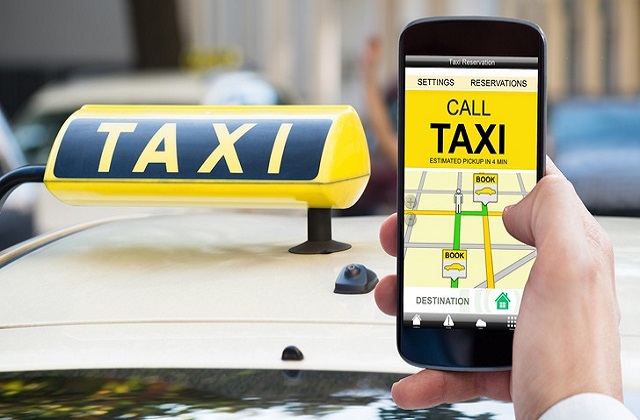 Close-up Of A Person Hand Holding Mobile Phone Booking Taxi